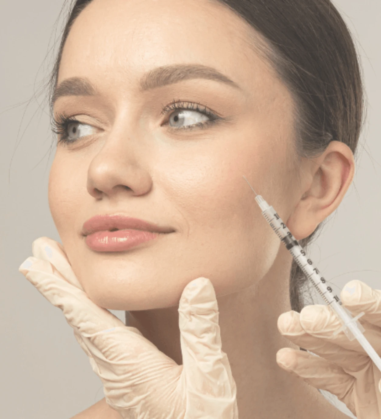 Medical professional performing botox injection Toronto treatment on cheek area for facial contouring and wrinkle reduction